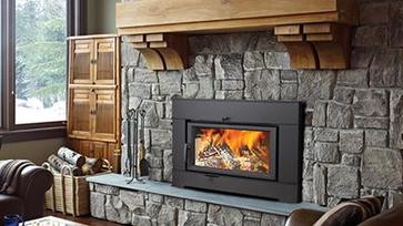 Wood burning fireplace insert with a fire burning 