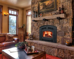 Wood burning fireplace, pearl model in living room with stone fireplace mantel